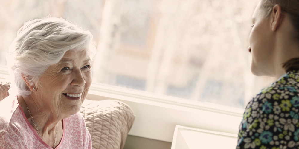 Younger woman and older woman talking Younger woman and older woman talking